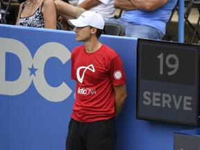 In this Friday, Aug. 3, 2018, photo, a ball boy stands next to the serve clock during a match between Kei Nishikori, of Japan, and Alexander Zverev, of Germany, at the Citi Open tennis tournament in Washington.