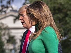 President Donald Trump and first lady Melania Trump arrive at the White House in Washington, Sunday, Aug. 19, 2018, after spending the weekend at his golf club in Bedminster, N.J.