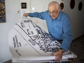 In this Sunday, Oct. 31, 2010 photo holocaust survivor Samuel Willenberg, who died 2016, displays a map of the Treblinka extermination camp during an interview with the Associated Press at his house in Tel Aviv, Israel. Ada Krystyna Willenberg, the widow of one revolt fighter Samuel Willenberg, appealed Thursday for a proper museum to be built at the site of the former camp. The current memorial consists of boulders bearing the names of locations that the inmates came from.
