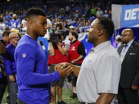New York Giants running back Saquon Barkley, left, meets with former Detroit Lions running back Barry Sanders before a preseason football game, Friday, Aug. 17, 2018, in Detroit.