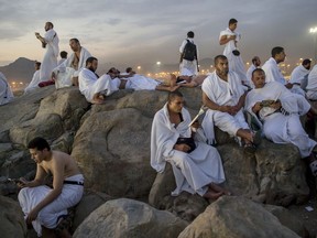 Muslim pilgrims pray on the Jabal Al Rahma holy mountain, or the mountain of forgiveness, at Arafat for the annual hajj pilgrimage outside the holy city of Mecca, Saudi Arabia, Monday, Aug. 20, 2018. More than 2 million Muslims have begun the annual hajj pilgrimage. The five-day pilgrimage represents one of the five pillars of Islam and is required of all able-bodied Muslims once in their life.