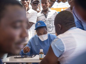 Nurses working with the World Health Organization (WHO) prepare to administer vaccines at the town all of Mbandaka on May 21, 2018 during the launch of the Ebola vaccination campaign.