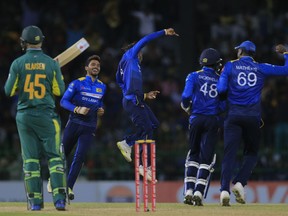 Sri Lanka's Akila Dananjaya, center, celebrates the dismissal of South Africa's Heinrich Klaasen with Angelo Mathews during their fifth one-day international cricket match in Colombo, Sri Lanka, Sunday, Aug. 12, 2018.
