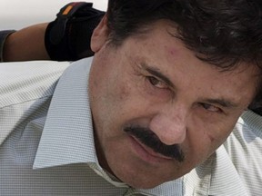 In this Feb. 22, 2014, file photo, Joaquin "El Chapo" Guzman is escorted to a helicopter in handcuffs by Mexican navy marines at a navy hanger in Mexico City.  A U.S. judge on Tuesday, Aug. 14, 2018 denied a request by the notorious Mexican drug lord to move his trial as a way to alleviate the public spectacle created by the intense security measures being used to transport him to court. The measures have included shutting down the Brooklyn Bridge for a police motorcade taking Guzman from a high-security jail in Manhattan to a Brooklyn courthouse where hes due to go on trial later this year.