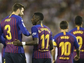 Barcelona's Ousmane Dembele celebrates with team mates scoring the opening goal during the Spanish La Liga soccer match between FC Barcelona and Valladolid at the Nuevo Jose Zorrilla stadium in Valladolid, Spain, Saturday, Aug. 25, 2018.