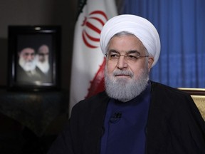 In this photo released by official website of the office of the Iranian Presidency, President Hassan Rouhani addresses the nation in a televised speech in Tehran, Iran, Monday, Aug. 6, 2018. Iranian President Hassan Rouhani struck a hard line Monday as the U.S. restored some sanctions that had been lifted under the 2015 nuclear deal. (Iranian Presidency Office via AP)