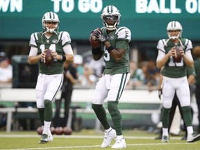 New York Jets quarterback Teddy Bridgewater (5) warms up with teammates Sam Darnold (14) and Josh McCown (15) before a preseason NFL football game against the Atlanta Falcons, Friday, Aug. 10, 2018, in East Rutherford, N.J.