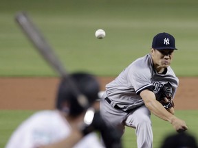 New York Yankees starting pitcher Masahiro Tanaka, of Japan, delivers during the first inning of a baseball game against the Miami Marlins, Tuesday, Aug. 21, 2018, in Miami.