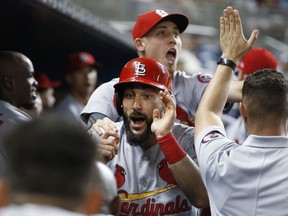 St. Louis Cardinals' Matt Carpenter, center celebrates with teammates after hitting a home run during the sixth inning of a baseball game against the Miami Marlins, Wednesday, Aug. 8, 2018, in Miami.