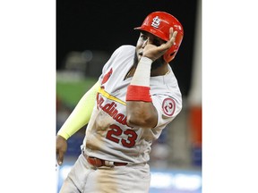 St. Louis Cardinals' Marcell Ozuna motions back to the dugout after getting a base hit during the eighth inning of a baseball game against the Miami Marlins, Monday, Aug. 6, 2018, in Miami. Ozuna returned for his first game at Marlins Park after being traded to St. Louis in the offseason. The Marlins defeated the Cardinals 2-1.