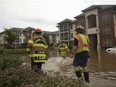 Members of the Campbell County Fire Department wade through water at an apartment complex Thursday, Aug. 2, 2018 in Lynchburg, Va. The National Weather Service said up to six inches of rain fell within hours, filling College Lake near Lynchburg beyond capacity. The service says a failure of the College Lake Dam could flood parts of Lynchburg with 17 feet of water in just seven minutes.