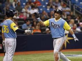 Tampa Bay Rays' Ji-Man Choi, right, celebrates with teammate Brandon Lowe during the third inning of a baseball game against the Boston Red Sox, Friday, Aug. 24, 2018, in St. Petersburg, Fla.