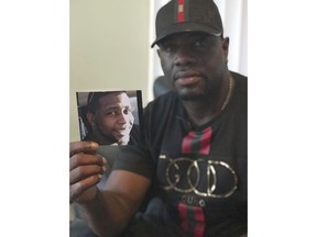 In an Aug. 7, 2018 photo, Michael McGlockton holds a photo of his son, Markeis McGlockton, in Clearwater, Fla. Markeis was shot and killed on July 19 in Clearwater, Florida during an argument over a parking spot. The shooter, Michael Drejka, said he was defending himself and is using Florida's controversial 'Stand Your Ground' defense.