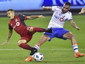 Toronto FC forward Sebastian Giovinco (10) is fouled by Montreal Impact defender Rudy Camacho (4) during first half MLS soccer action in Toronto on Saturday, Aug. 25, 2018. The referee played the advantage for Toronto to let the play continue.