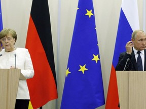 FILE - In this May 18, 2018 file photo Russian President Vladimir Putin, right, and German Chancellor Angela Merkel attend news conference after their meeting at Putin's residence in the Russian Black Sea resort of Sochi, Russia. Merkel and Putin will meet on Saturday in the German government's guesthouse Meseberg, north of Berlin, Saturday, Aug. 18, 2018. The topics will include the civil war in Syria, the conflict in Ukraine, and energy questions.
