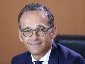 FILE - In this July 18, 2018 file photo German Foreign Minister Heiko Maas smiles prior to the weekly cabinet meeting at the chancellery in Berlin, Germany. Maas is setting out proposals for what he calls a future "balanced partnership" with the United States that would include setting up channels for financial payments which are independent of the U.S.