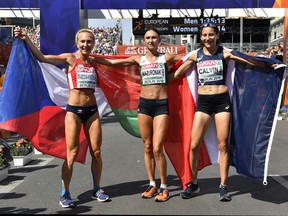Belarus' Volha Mazuronak is flanked by Czech Republic's bronze medal winner Eliska Stankova, left, and France's silver medal winner Clemence after winning the gold medal in the women's marathon at the European Athletics Championships in downtown Berlin, Germany, Sunday, Aug. 12, 2018.