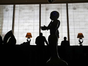FILE - In this Nov. 15, 2017, file photo, a robot named Pepper that is programmed to interact with guests, stands in the lobby of the Mandarin Oriental in Las Vegas. Hilton is set to begin rebranding the Mandarin Oriental hotel on the Las Vegas Strip as a Waldorf Astoria. The transition that will start Friday, Aug. 31, 2018, at the 389-room, casino-less property will lead to renovations and mark the debut of another luxury brand on the Strip.