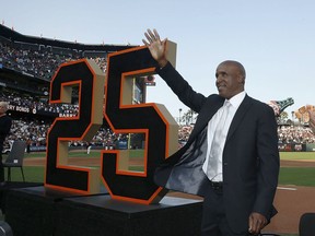 Former San Francisco Giants player Barry Bonds waves during a ceremony to retire his jersey number before a baseball game between the Giants and the Pittsburgh Pirates in San Francisco, Saturday, Aug. 11, 2018.
