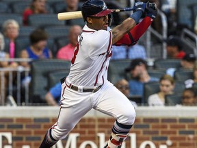 Atlanta Braves' Ronald Acuna Jr. hits a single in the first inning of a baseball game against the Colorado Rockies in Atlanta, Friday, Aug. 17, 2018.