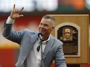 Former Atlanta Braves third baseman and Baseball Hall of Fame member Chipper Jones waves to the crowd as he speaks during a ceremony before a baseball game against the Milwaukee Brewers, Friday, Aug. 10, 2018, in Atlanta.