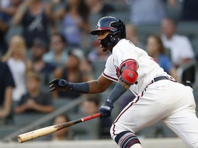 Atlanta Braves' Ronald Acuna Jr. runs to first base after hitting a single in the first inning of a baseball game against the Colorado Rockies on Thursday, Aug. 16, 2018, in Atlanta.