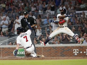 Atlanta Bravess Ronald Acuna Jr. reacts as Dansby Swanson (7) scores on a Julio Terheran base hit during the fifth inning of a baseball game against the Colorado Rockies on Thursday, Aug. 16, 2018, in Atlanta. The Rockies won 5-3.