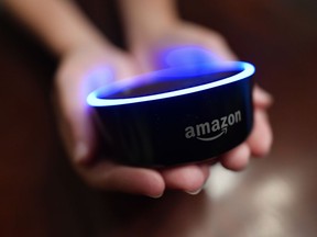 In this Thursday, Aug. 16, 2018, photo a child holds his Amazon Echo Dot in Kennesaw, Ga. Amazon updated its voice assistant with a feature that can make Alexa more kid-friendly. When the FreeTime feature is activated, Alexa answers certain questions differently.