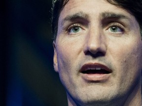 Prime Minister Justin Trudeau answers reporters' questions concerning Canada's relationship with Saudi Arabia during a visit to CAE in Montreal, Wednesday, August 8, 2018.