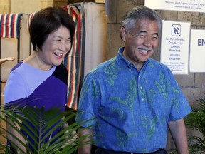 In this Wednesday, Aug. 8, 2018 photo, Hawaii Gov. David Ige, right, and first lady Dawn Amano Ige smile after voting early in the state's primary election in Honolulu. Ige is seeking the nomination for a second term in office in Saturday's Democratic primary. He is being challenged by U.S. Rep. Colleen Hanabusa, who is giving up her seat in Congress to challenge the governor.