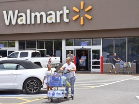 Taro and Taina Leong of Kekaha, Kauai, are among the customers leaving a Walmart store with supplies to prepare for Hurricane Lane, Tuesday, Aug. 21, 2018 in Lihue, on the island of Kauai, Hawaii. Hurricane Lane "is forecast to move dangerously close to the main Hawaiian islands as a hurricane later this week, potentially bringing damaging winds and life-threatening flash flooding from heavy rainfall," the weather service's Central Pacific Hurricane Center warned as it got closer to the state.