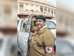 Indian lawmaker Naramalli Sivaprasa stands dressed like Adolf Hitler outside the Indian parliament building in New Delhi, India, Friday, Aug. 10, 2018.