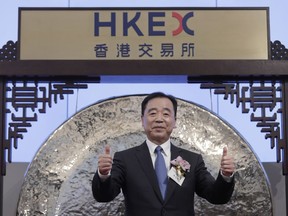 China Tower Corp. Ltd. Chairman Tong Jilu gestures during the listing ceremony at the Hong Kong Stock Exchange in Hong Kong Wednesday, Aug. 8, 2018. China Tower, the state-backed company that operates the world's largest network of telecoms towers, made a debut in Hong Kong Stock Exchange on Wednesday, raising US$6.9 billion.