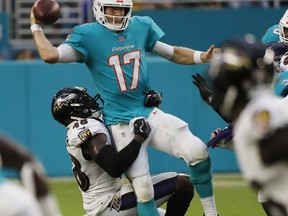 Baltimore Ravens linebacker Patrick Onwuasor (48) sacks Miami Dolphins quarterback Ryan Tannehill (17) during the first half of a preseason NFL game, Saturday, Aug. 25, 2018, in Miami Gardens, Fla.