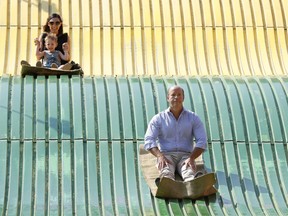 Rep. John Delaney, D-Md., rides down the giant slide during a visit to the Iowa State Fair, Friday, Aug. 10, 2018, in Des Moines, Iowa.