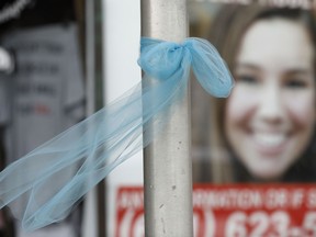 A ribbon for missing University of Iowa student Mollie Tibbetts hangs on a light post, Tuesday, Aug. 21, 2018, in Brooklyn, Iowa. Tibbetts was reported missing from her hometown in the eastern Iowa city of Brooklyn in July 2018.