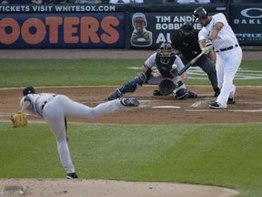 Chicago White Sox's Jose Abreu hits an RBI double off of New York Yankees starting pitcher Luis Severino during the first inning of a baseball game Wednesday, Aug. 8, 2018, in Chicago.