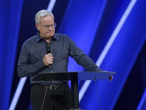 FILE - In this Tuesday, April 10, 2018 file photo, Willow Creek Community Church Senior Pastor Bill Hybels stands before his congregation in South Barrington, Ill., where he announced his early retirement effective immediately, amid a cloud of misconduct allegations involving women in his congregation. The announcement was made during a special meeting at the church, one of the nation's largest evangelical churches, which he founded.