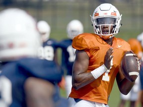 FILE - In this Aug. 14, 2018, file photo, Illinois quarterback AJ Bush (1) throws during NCAA college football training camp in Urbana, Ill.  After an intensive three-man competition, and less than a week before the season opener at home against Kent State, Illinois coach Lovie Smith has picked senior transfer AJ Bush as his starting quarterback. Bush beat out last year's starter and a promising three-star freshman recruit.