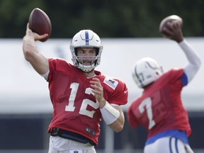 Indianapolis Colts quarterbacks Andrew Luck (12) and Jacoby Brissett throw during practice at the NFL team's football training camp in Westfield, Ind., Sunday, Aug. 5, 2018.