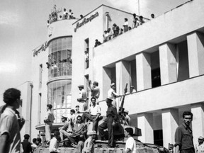 FILE - In this Aug. 19, 1953 file photo, a royalist tank moves into the courtyard of Tehran Radio a few minutes after pro-shah troops occupied the place during the coup which ousted Prime Minister Mohammad Mossadegh and his government. In 2018, as Iran deals with President Donald Trump's decision to pull America from the nuclear deal with world powers, more are invoking the 1953 CIA-backed coup that toppled Mossadegh as proof the U.S. cannot be trusted. (AP Photo, File)