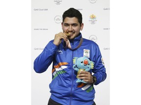 In this April 13, 2018, file photo, Anish Bhanwala of India celebrates with his gold medal at the men's 25m Rapid Fire Pistol final at the Belmont Shooting Centre during the 2018 Commonwealth Games in Brisbane, Australia. At 15 and still at high school, Anish was India's youngest gold medalist at the Commonwealth Games on Australia's Gold Coast in April when he won the 25-meter rapid fire pistol shooting event in a meet record.