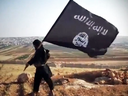 An Islamic State fighter carries the terrorist group's flag in an undated video.