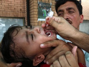 A Pakistani health worker gives a polio vaccine to a child, in Peshawar, Pakistan, Monday, Aug. 6, 2018. A Pakistani health official says authorities have launched a week-long anti-polio campaign touted as a 'final push' against the crippling disease.