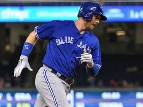 Justin Smoak of the Toronto Blue Jays circles the bases after hitting a pinch-hit grand slam homerun in the ninth inning of Friday's MLB game against the Miami Marlins in Miami. The Jays were 6-5 winners.