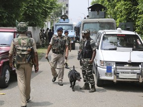 Indian security officers patrol outside the residence of Farooq Abdullah, India's member of parliament and Kashmir's former top elected official, on the outskirts of Jammu, India, Saturday, Aug. 4, 2018. Security guards posted at the residence of Abdullah shot and killed a young man after he allegedly forced his entry into the residence on Saturday, top police officer S.P. Vaid said. Vaid said the man traveling in a car was unarmed and gatecrashed into the residence in southern Jammu city. He scuffled with security guards before he was shot to death.