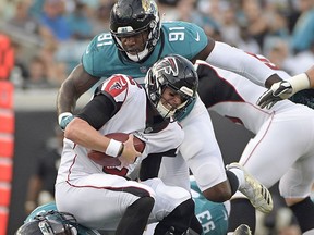 Atlanta Falcons quarterback Matt Ryan, center, is sacked by Jacksonville Jaguars defensive tackle Malik Jackson (97) and defensive end Yannick Ngakoue (91) during the first half of an NFL preseason football game Saturday, Aug. 25, 2018, in Jacksonville, Fla.