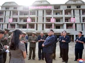 In this undated photo, provided on Aug. 19, 2018, by the North Korean government, North Korean leader Kim Jong Un, center, visits a construction site during a visit to the city of Samjiyon, a remote northern city near the Chinese border.  North Korea is speeding up the pace of a massive nationwide construction campaign ahead of its 70th anniversary in what leader Kim has described as a symbolic battle against anyone who would oppose his country. Independent journalists were not given access to cover the event depicted in this image distributed by the North Korean government. The content of this image is as provided and cannot be independently verified. Korean language watermark on image as provided by source reads: "KCNA" which is the abbreviation for Korean Central News Agency. (Korean Central News Agency/Korea News Service via AP)