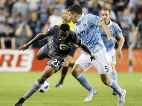 Minnesota United forward Mason Toye (23) loses control of the ball as Sporting Kansas City defender Matt Besler (5) defends during the first half of an MLS soccer match in Kansas City, Kan., Saturday, Aug. 25, 2018.