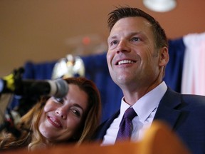 Kansas Republican gubernatorial candidate Kris Kobach and his wife Heather take the stage to thank their supporters and send them home for the night after problems with polls in Johnson County, Kan., delayed the final results until the early morning on Wednesday, Aug. 8, 2018, at the Capitol Plaza Hotel in Topeka, Kan.